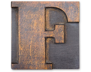Antique wood cut block of the letter F